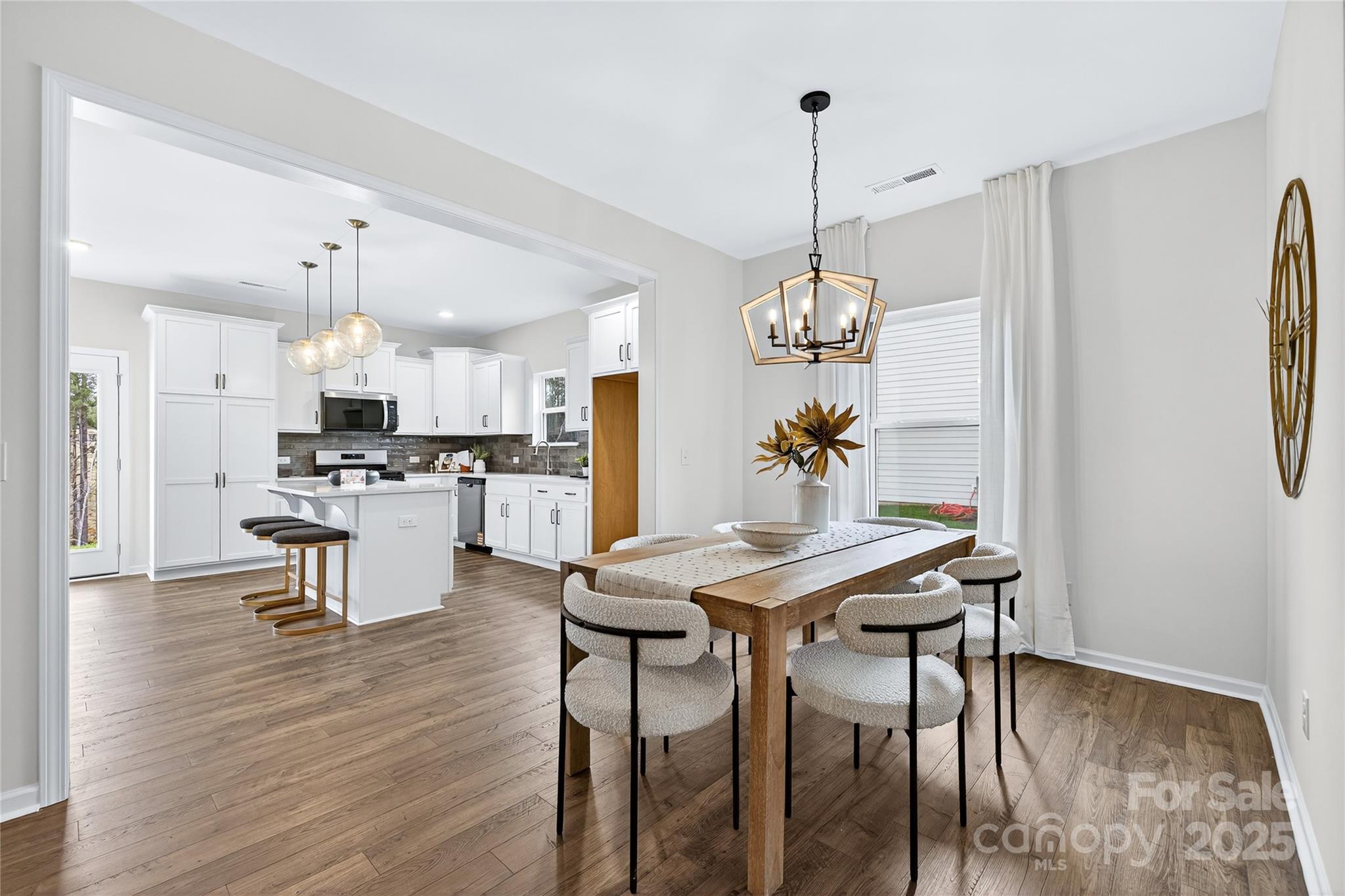 10423 Lakeshore Drive, Unit 71 Lancaster, SC 29720 - Photo 10 of 31 a view of a dining room with furniture a chandelier and wooden floor