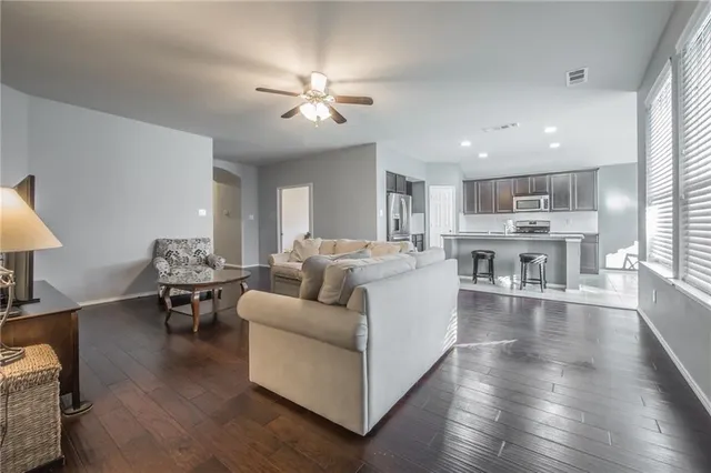 a living room with furniture and kitchen view