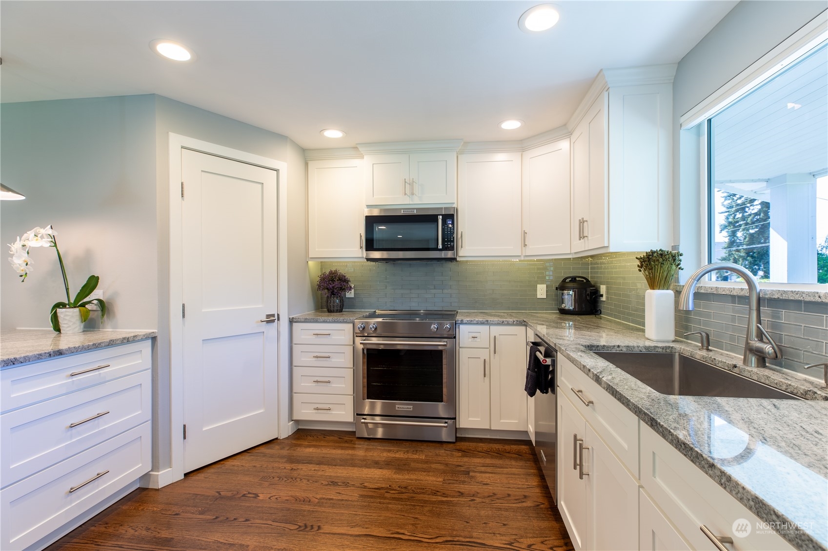 8498 Talbot Road Edmonds, WA 98026 - Photo 15 of 30 a kitchen with granite countertop a stove sink and cabinets
