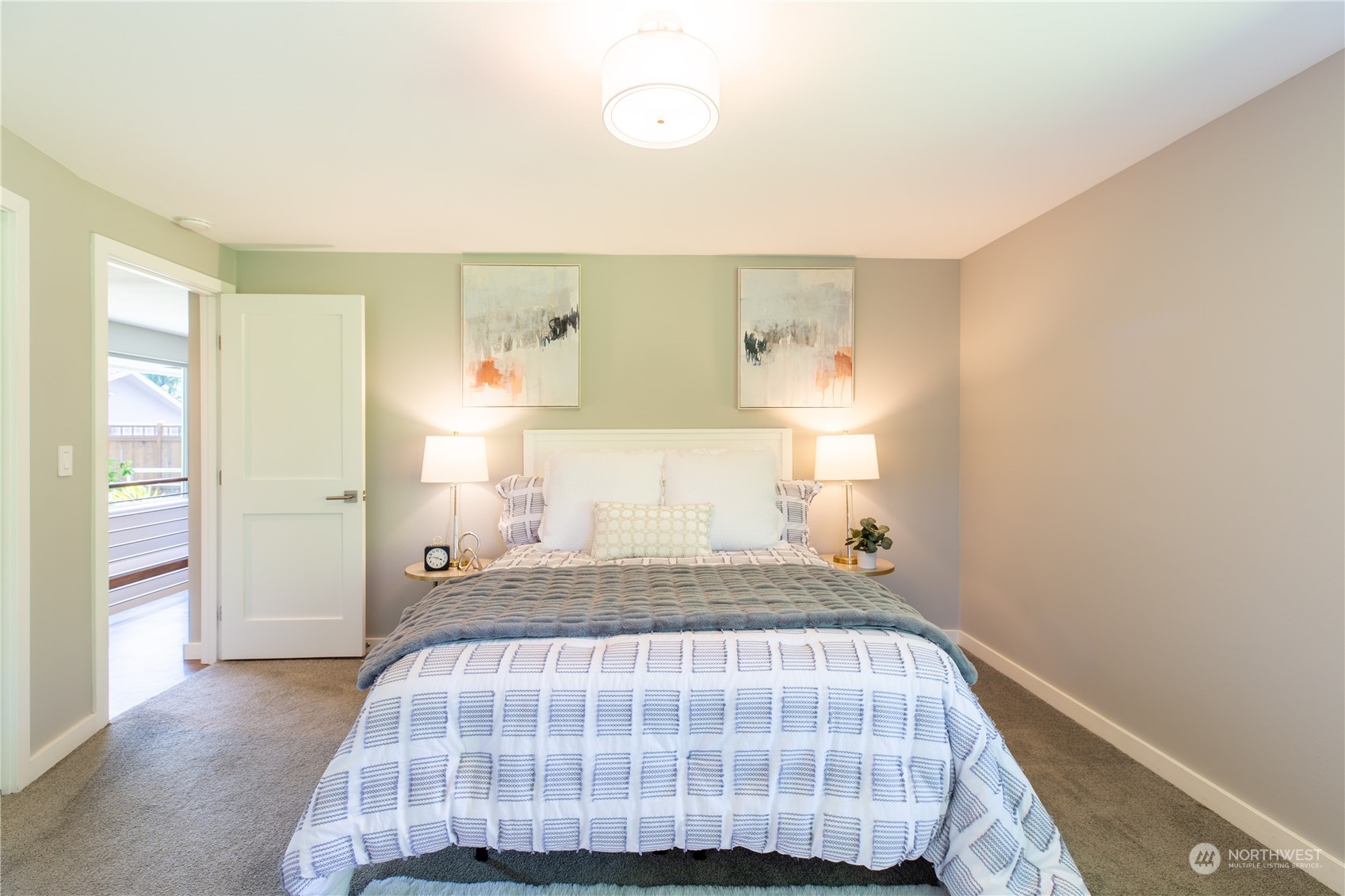 8498 Talbot Road Edmonds, WA 98026 - Photo 18 of 30 a bedroom with a bed and wooden floor
