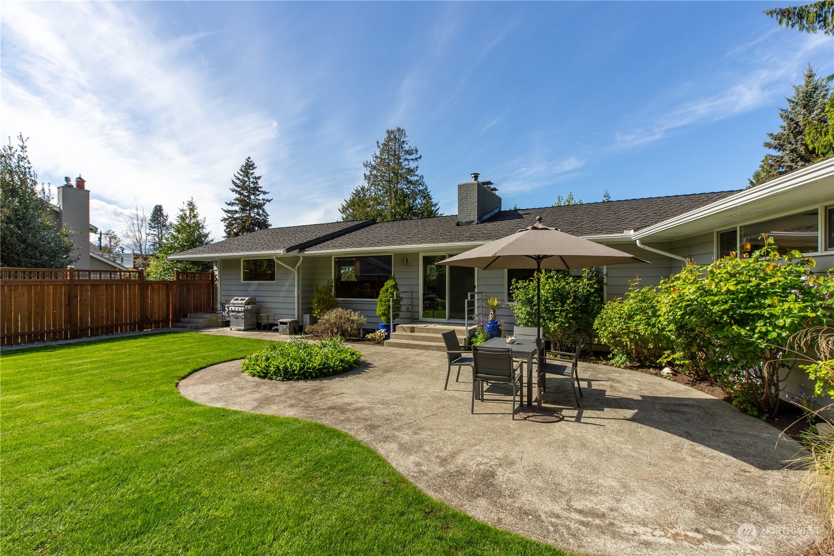 8498 Talbot Road Edmonds, WA 98026 - Photo 27 of 30 a view of a patio with table and chairs under an umbrella