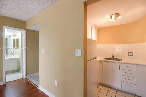 a view of a kitchen from the hallway