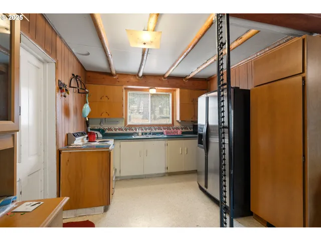 a kitchen with refrigerator and window