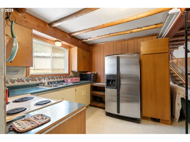 a kitchen with refrigerator and window
