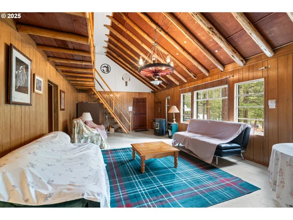 a living room with furniture a wooden floor and next to a window