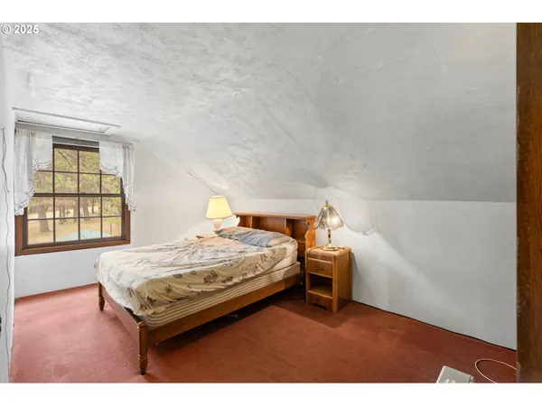 a bedroom with a bed and window