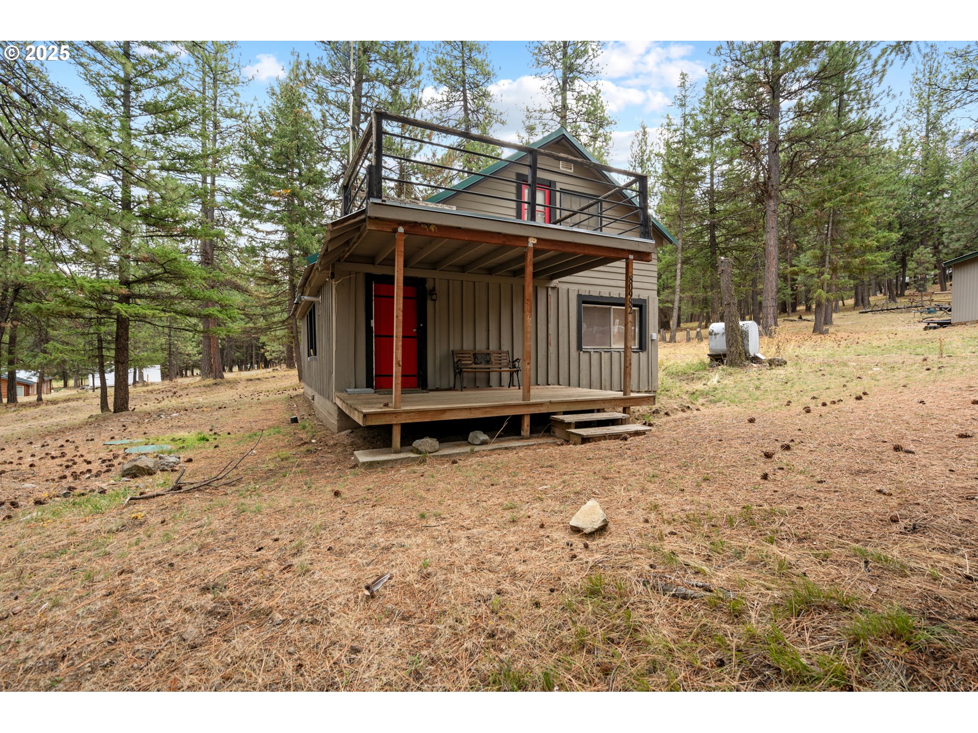 80982 Cougar Lane Heppner, OR 97836 - Photo 25 of 46 a view of a wooden house with a yard covered in snow