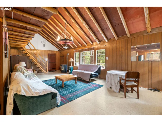 a living room with furniture a fireplace and a large window