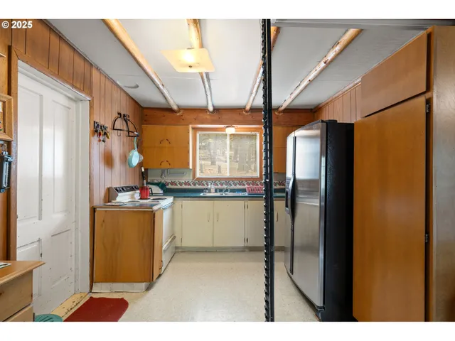a kitchen with refrigerator and cabinets