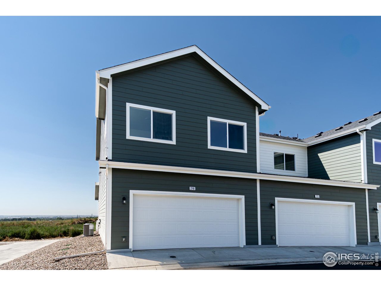 3748 Pinnacles Court Evans, CO 80620 - Photo 11 of 14 a front view of a house with a yard