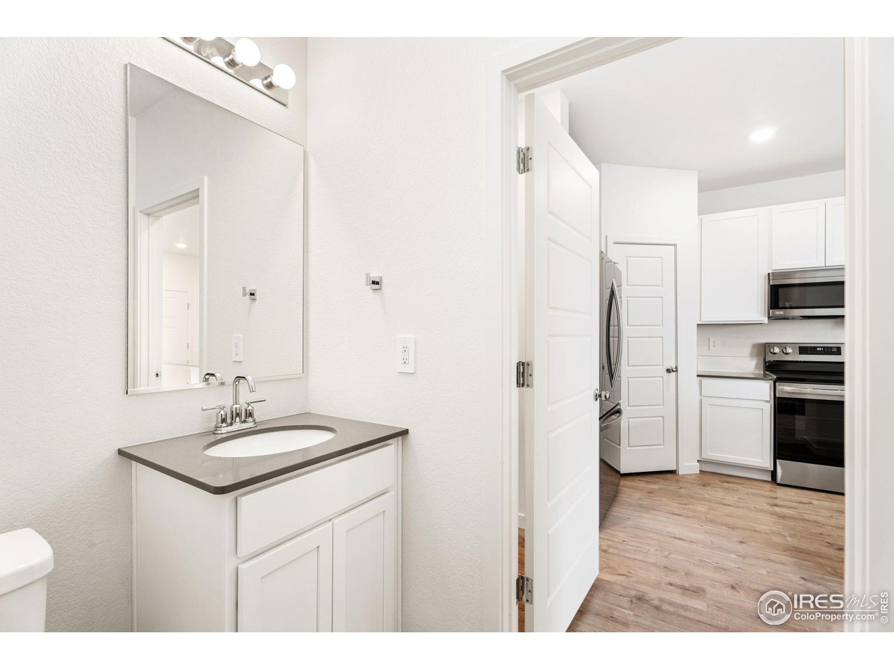 3748 Pinnacles Court Evans, CO 80620 - Photo 5 of 14 a bathroom with a sink and a mirror
