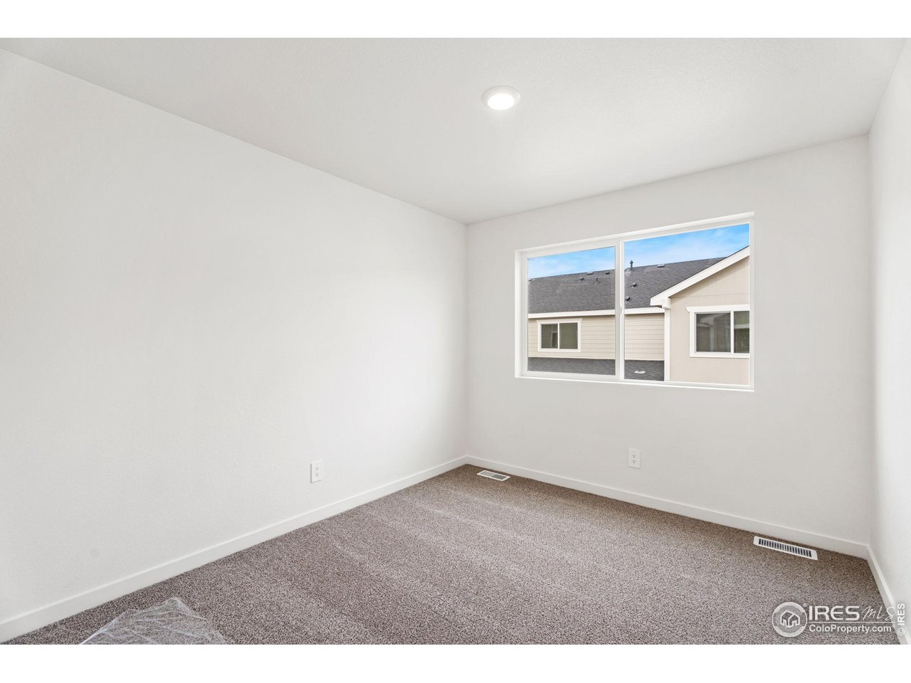 3748 Pinnacles Court Evans, CO 80620 - Photo 6 of 14 an empty room with windows