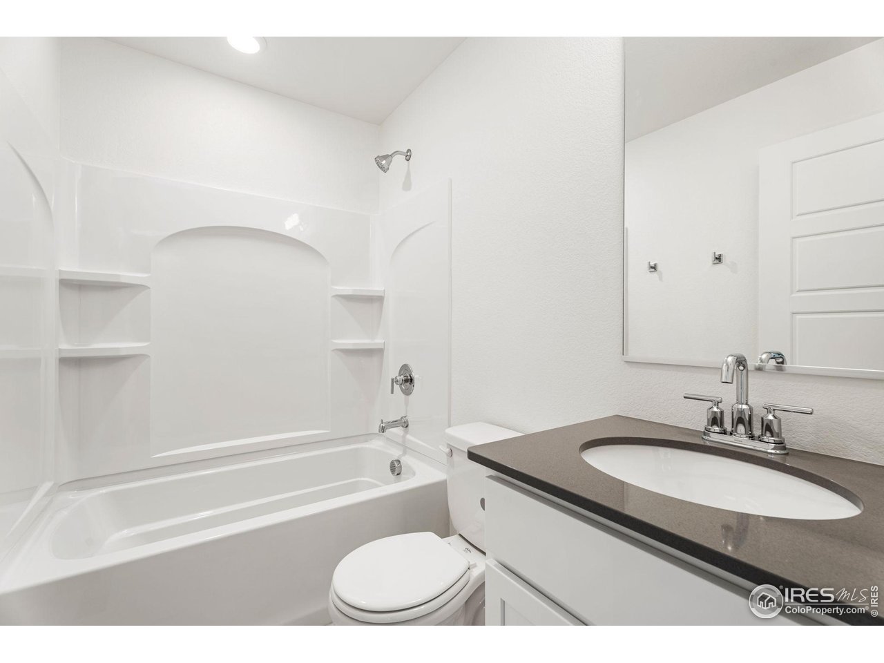 3748 Pinnacles Court Evans, CO 80620 - Photo 8 of 14 a bathroom with a granite countertop sink toilet and shower