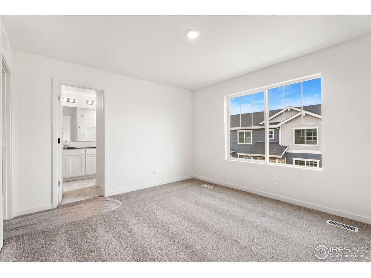 3748 Pinnacles Court Evans, CO 80620 - Photo 9 of 14 a view of an empty room with a window