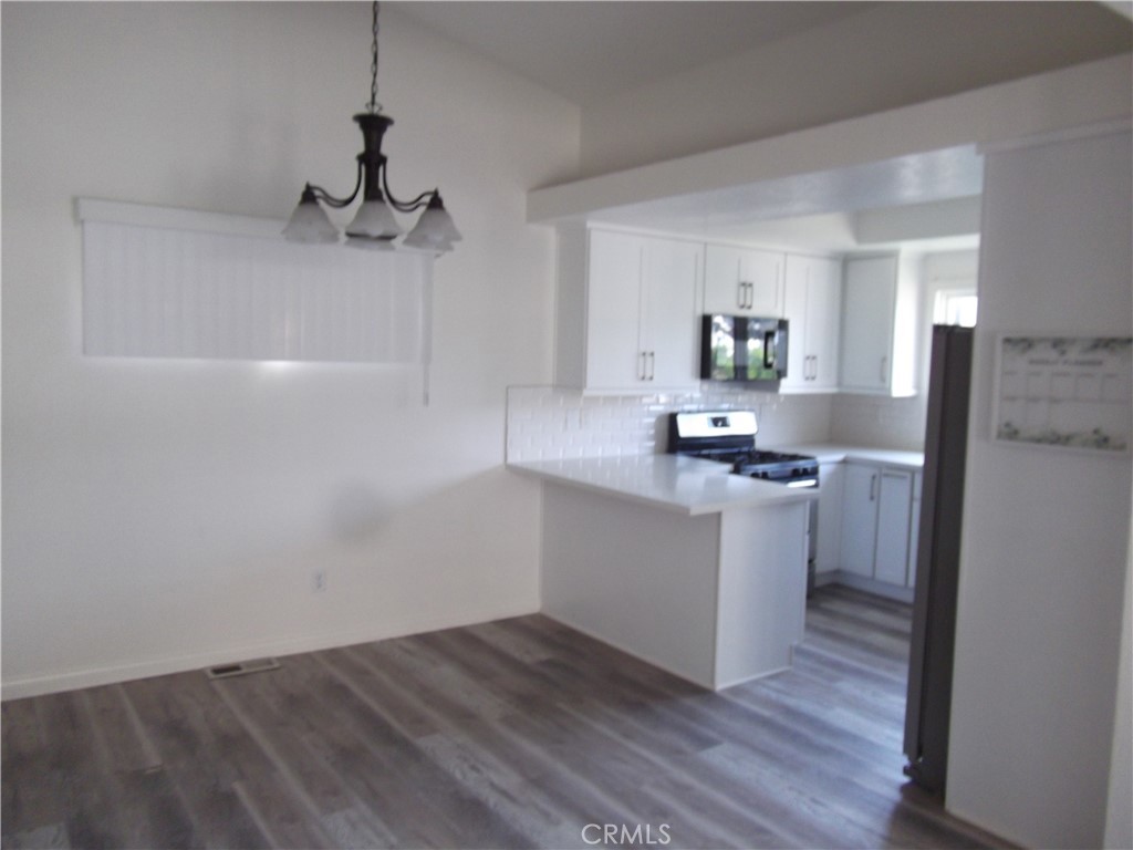 34152 Crystal Lantern Dana Point, CA 92629 - Photo 6 of 21 a kitchen with a refrigerator and a stove top oven