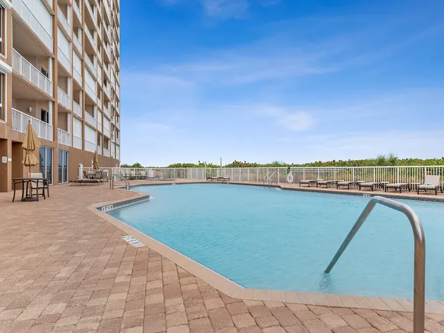 a view of outdoor space with swimming pool and seating