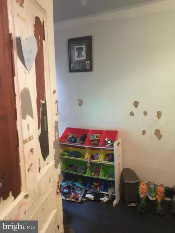 a room with a bed and wooden floor