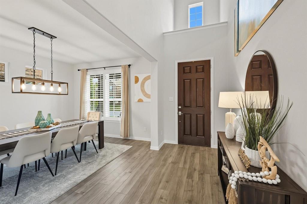 1724 Wassel Road Fort Worth, TX 76052 - Photo 3 of 24 Entryway featuring a dark wood six-panel door, wood-finish flooring, and a double-height ceiling