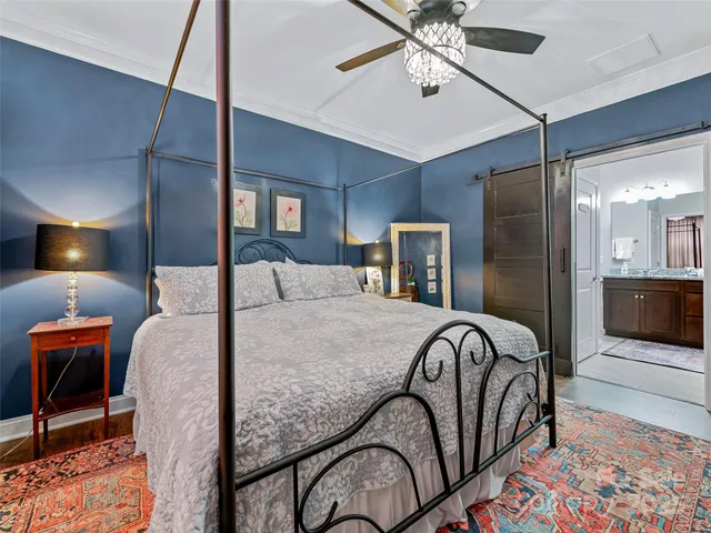 a bed sitting in a room next to a lamp