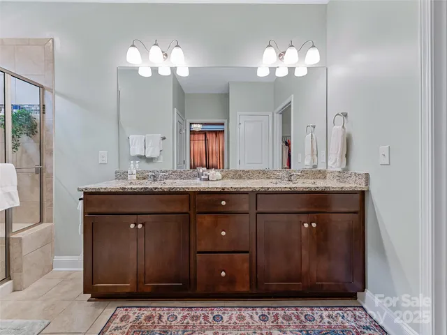 a bathroom with a granite countertop sink a mirror and a vanity