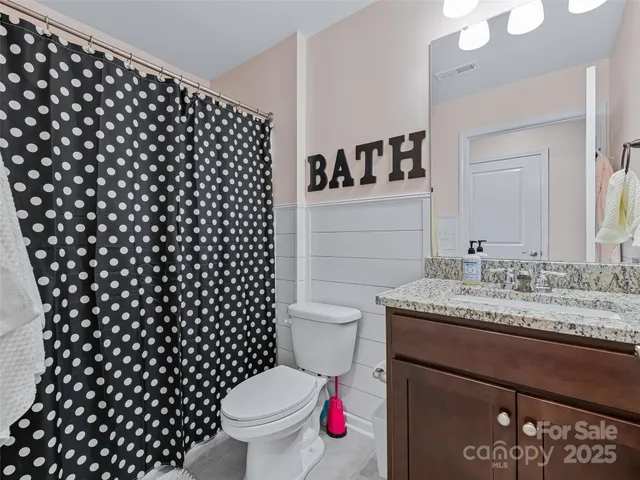 a bed sitting in a bedroom next to a window and a larger closet