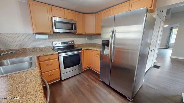 a kitchen with a refrigerator sink and microwave