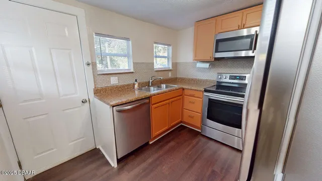 a kitchen with a sink stove and microwave