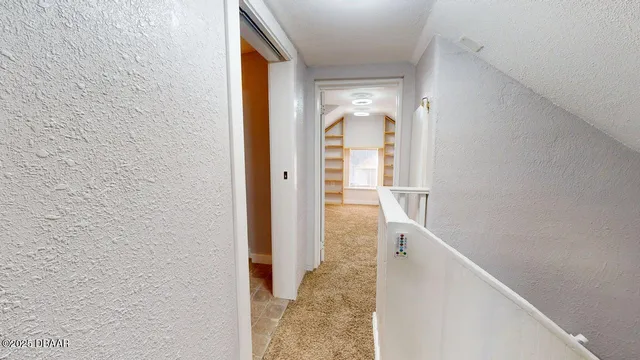 a view of a bathroom with mirror and shower