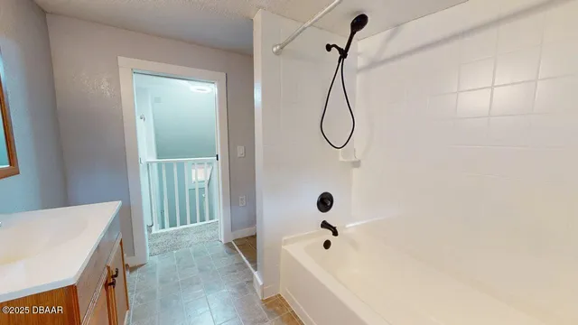 a bathroom with a shower and a window