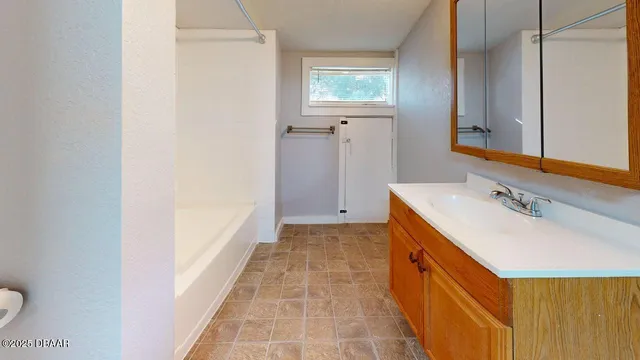 a view of a house with backyard sitting area and garden