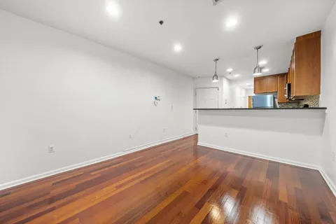a view of a kitchen with a sink and wooden floor