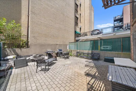 a view of a patio with couple of chairs