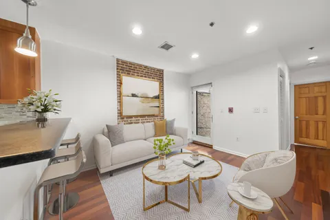 a living room with furniture and a potted plant