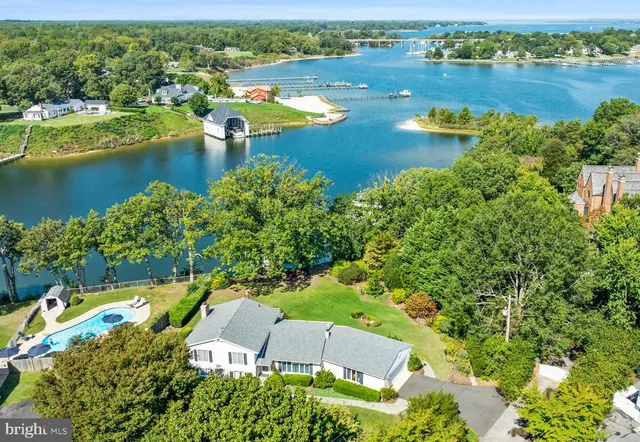 an aerial view of a houses with a lake