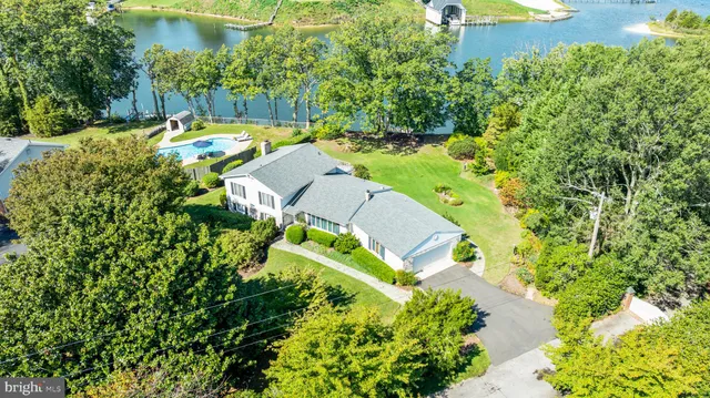 a kitchen with stainless steel appliances a stove a refrigerator cabinets and a dining table