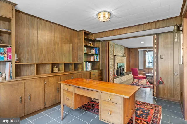 a view of a hallway with wooden floor and windows