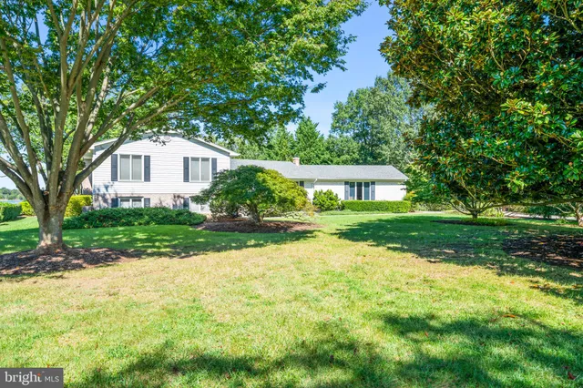a living room with furniture a fireplace and a table