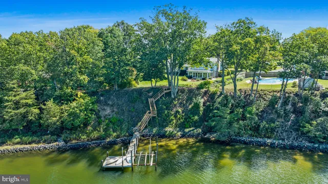 an aerial view of a house with a yard and trees