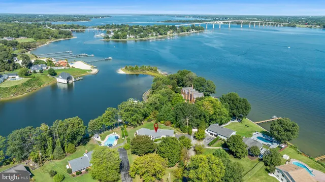 an aerial view of a house with a yard and swimming pool