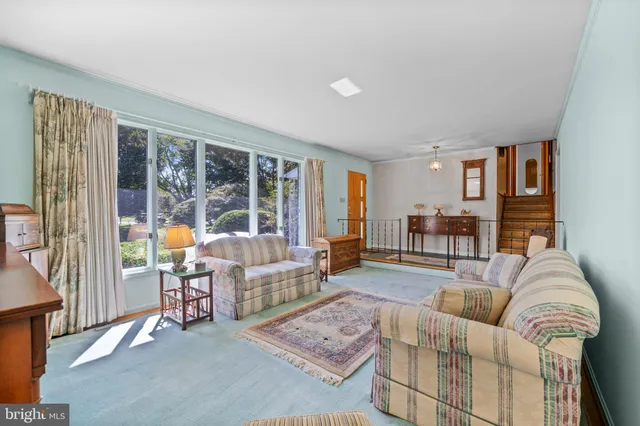 a front view of a house with a yard and potted plants