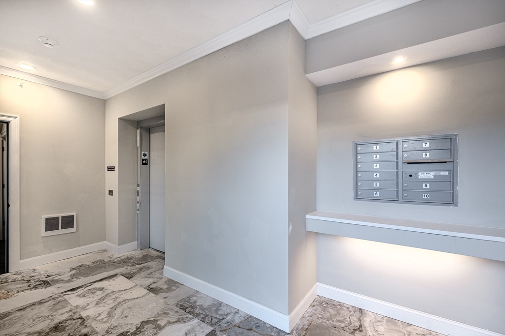 119-121 Addison Street, Unit 3 Boston, MA 02128 - Photo 11 of 13 a view of a bedroom with a bed and wooden floor