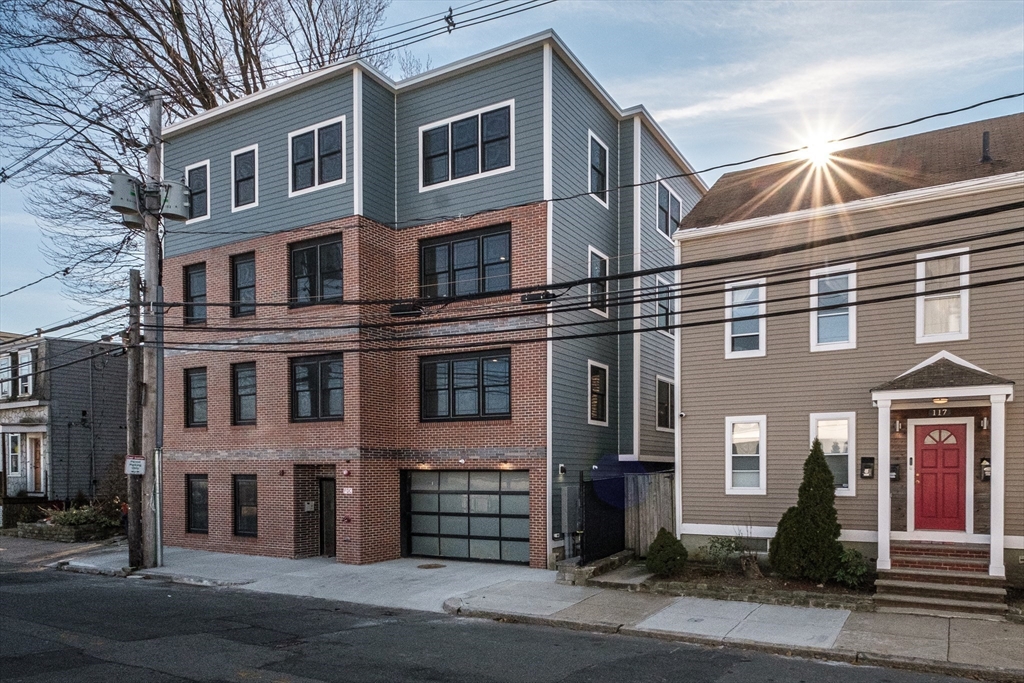 119-121 Addison Street, Unit 3 Boston, MA 02128 - Photo 8 of 13 a front view of a multi story residential apartment building