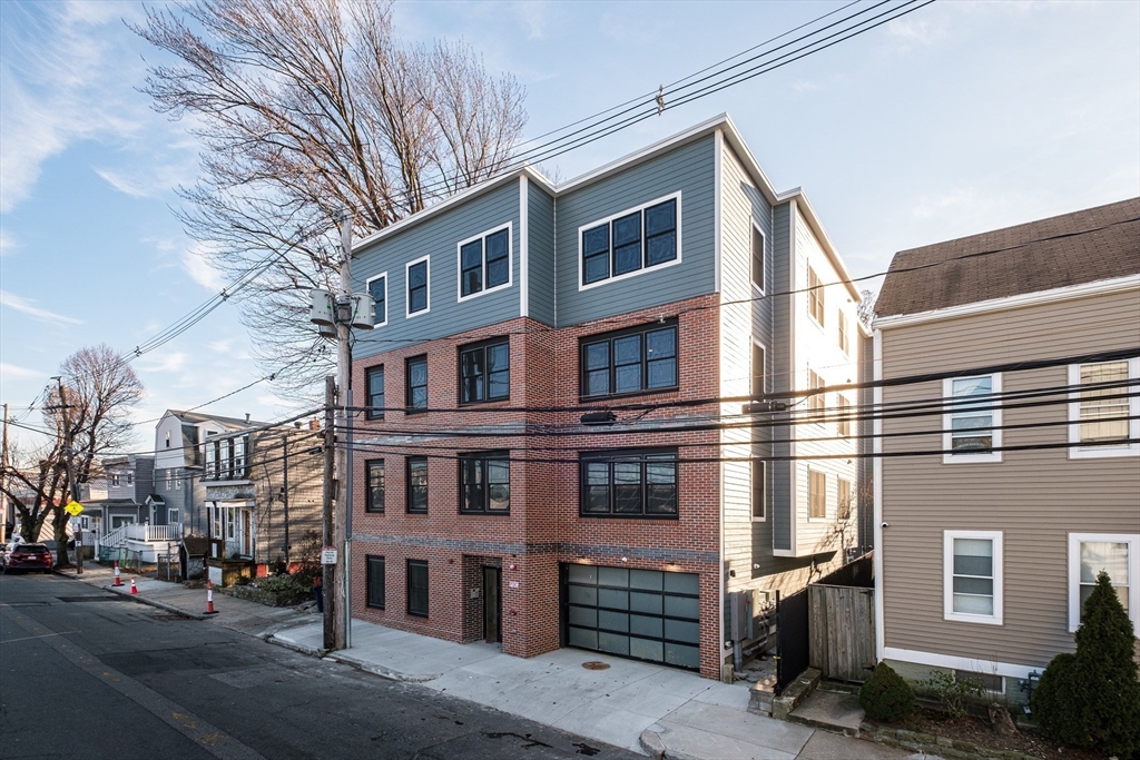 119-121 Addison Street, Unit 3 Boston, MA 02128 - Photo 10 of 13 a front view of a building with a street