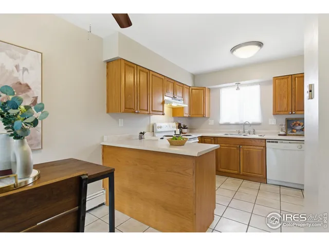 a kitchen with a sink refrigerator and cabinets