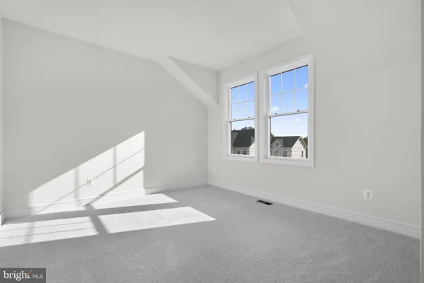 a view of an empty room with windows