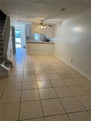 a view of a livingroom with furniture and an empty room