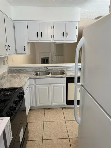 a kitchen with a stove top oven and cabinets