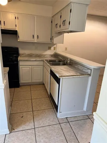 a kitchen with a sink cabinets and utility
