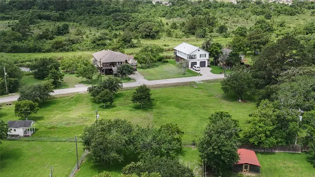 a aerial view of a house with a yard and lake