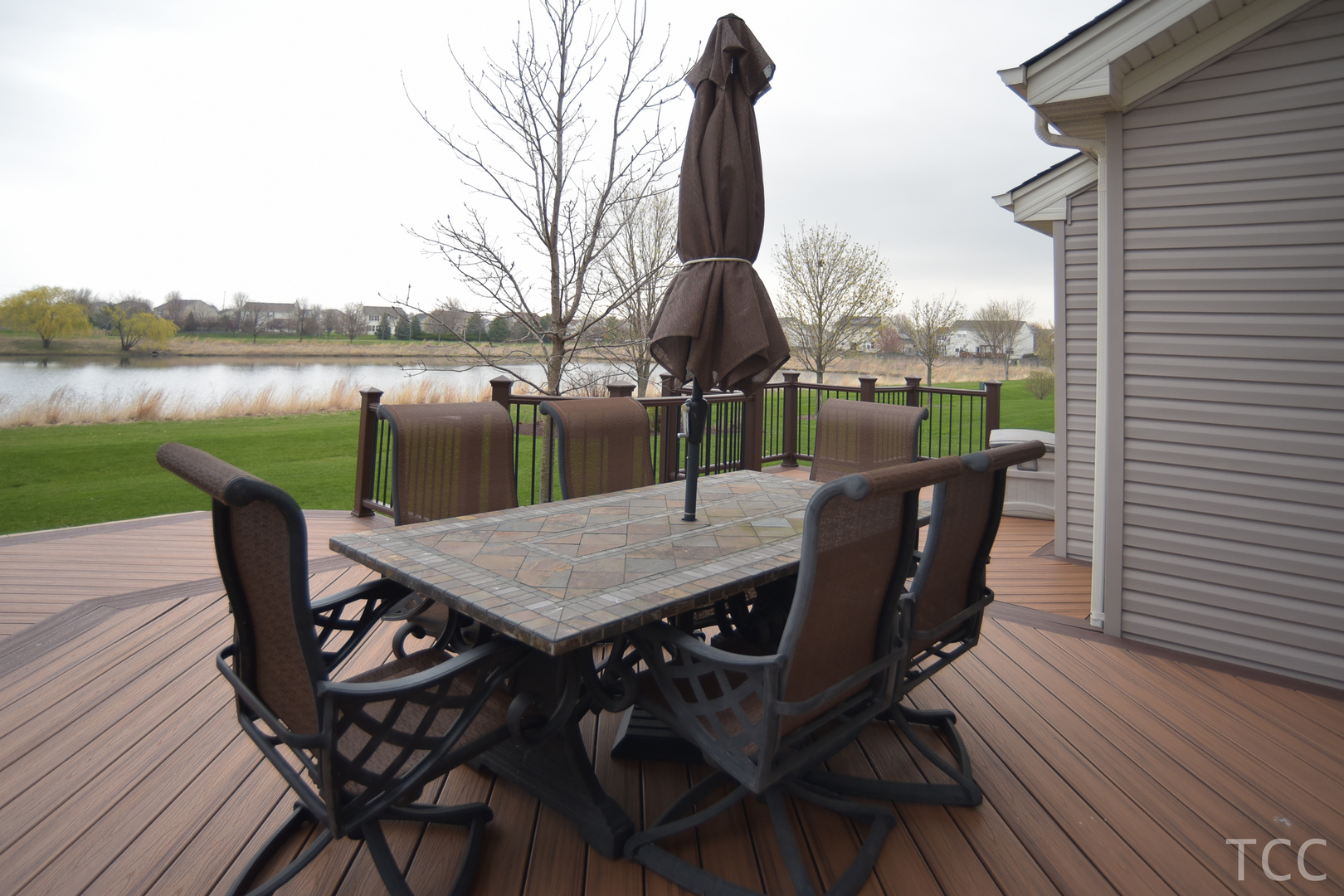 3050 Patterson Road Montgomery, IL 60538 - Photo 22 of 27 a view of a roof deck with table and chairs and wooden floor